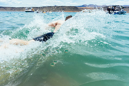 man wearing black shorts facing the wave on the ocean thumbnail
