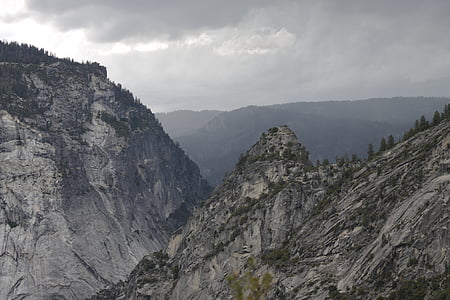 gray rock mountains under gray clouded sky at daytime thumbnail