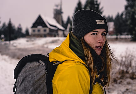 selective focus photography of woman wearing yellow jacket thumbnail