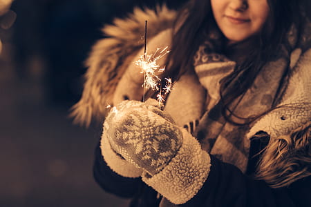 woman in gray and white gloves holding firecracker thumbnail