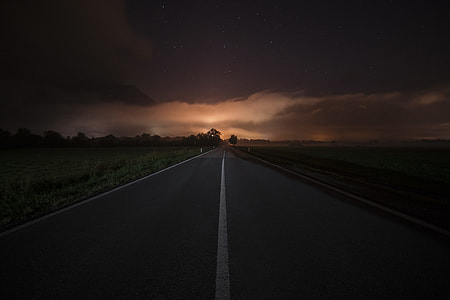 photo of gray concrete road during night time thumbnail