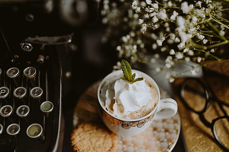 Coffee in a decorative cup with a golden ornament thumbnail