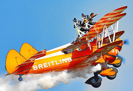 two person on top of jet doing tricks while in flight thumbnail