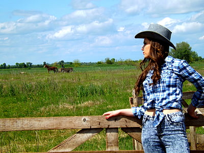 woman standing near brown wooden rail looking at brown horse thumbnail