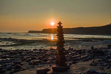 cairn on seashore during daytime thumbnail