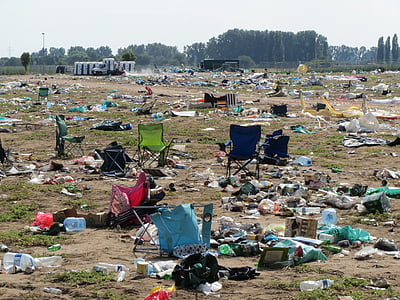 assorted-color camping chairs and garbages on green grass during daytime thumbnail