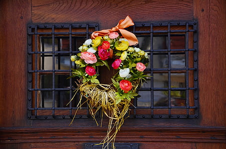 pink and yellow floral wreath hanged on window thumbnail