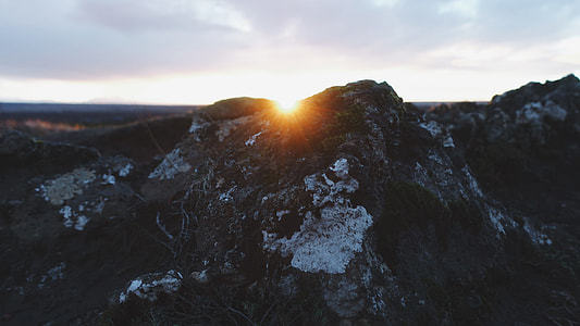 gray rock formation under white cloudy sky at daytime thumbnail