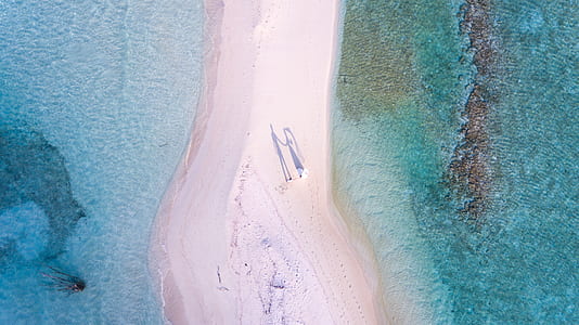 aerial photo of sand between body of water thumbnail