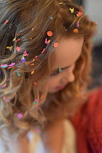 Shallow Focus Photography of Brown Haired Woman With Confetti on Hair thumbnail