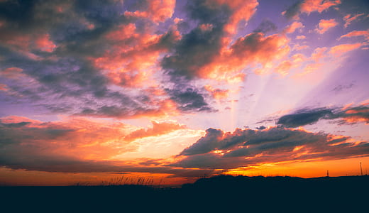 sunrays through clouds at sunset thumbnail