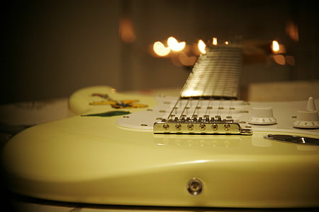 selective focus photography of white electric guitar thumbnail