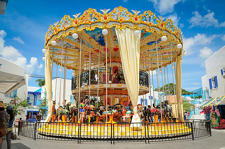 white and brown carousel with people photo thumbnail