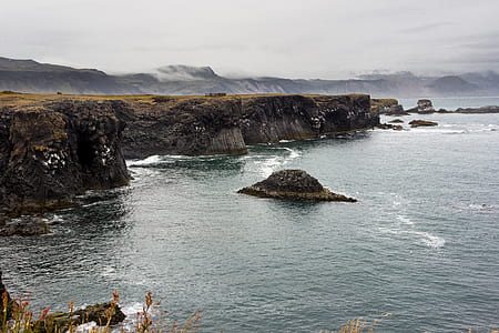 sea stack near mountains thumbnail