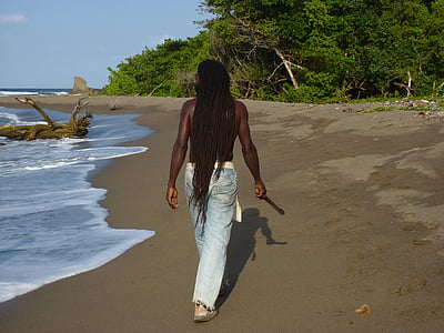 man walking on shore during daytime thumbnail