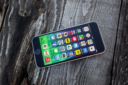 High resolution shot of the iPhone 6 mobile smartphone on a wood textured background thumbnail