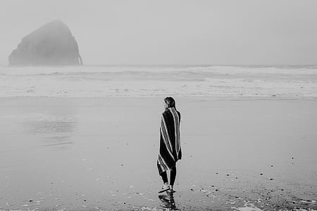 grayscale photography of woman wearing coat near boy of water thumbnail