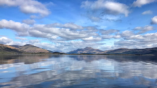 calm body of water surrounded by rock formations thumbnail