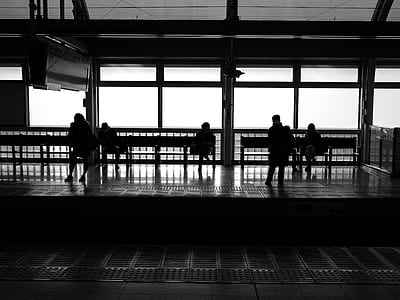 grayscale photo of people waiting inside train station thumbnail