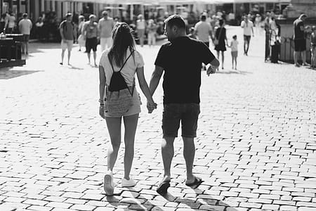 Grayscale Photography of Woman and Man Holding Hands While Walker thumbnail