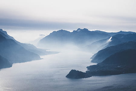 body of water surrounded by mountains thumbnail