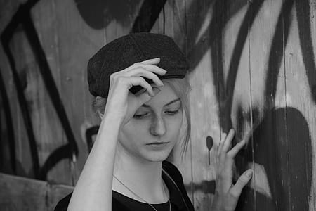 Woman Holding Her Cap in Grayscale thumbnail