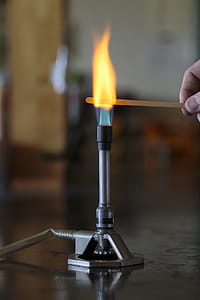 Sodium solution burning on a wooden splint in a bunsen burner flame. thumbnail
