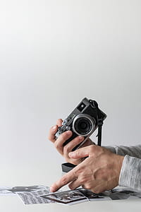 person holding DSLR camera thumbnail