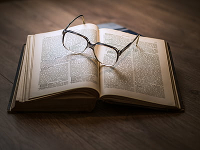 eyeglasses on top of opened book thumbnail