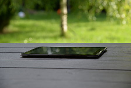 black tablet computer with black screen on table thumbnail