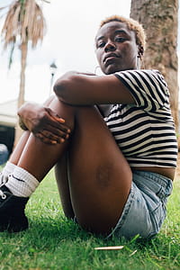 Woman wearing striped top Sitting Near Trees thumbnail