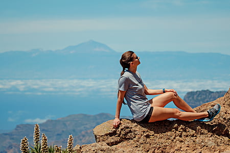 hiking woman laying on rock formation thumbnail