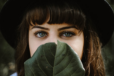 woman holding green leaf thumbnail