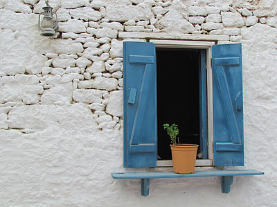 brown flower pot on wall mount rack near window on wall thumbnail