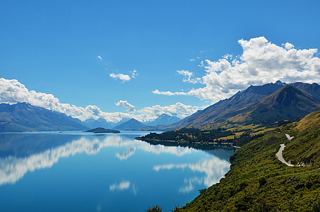 calm lake beside green mountain thumbnail