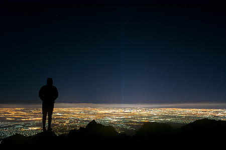 silhouette of person standing on mountain thumbnail