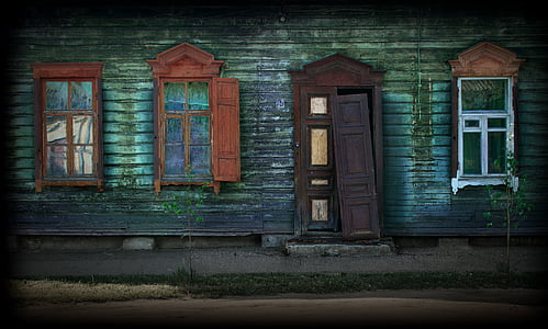 green wooden house with brown wooden door thumbnail