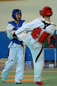 two men sparring on orange and green mat thumbnail