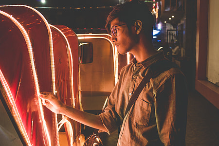 man wearing gray button-up polo shirt holding yellow LED strip thumbnail