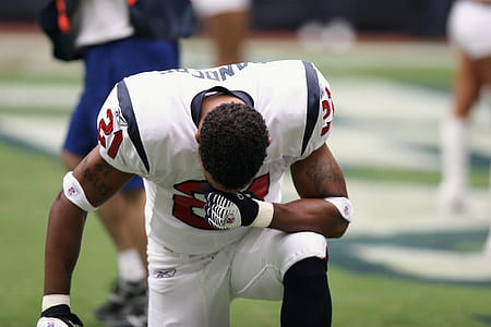 footballer bowing down on knee thumbnail
