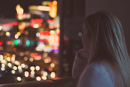 brown hair woman looking throught the window thumbnail