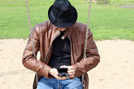 man sitting on swing under the sun thumbnail