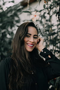 woman smiling near white hibiscus tree thumbnail