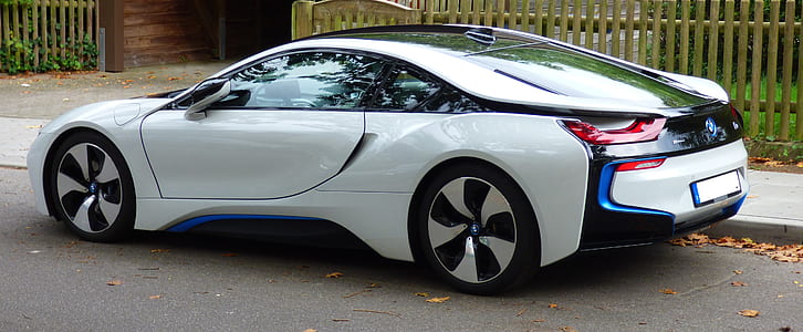 white and black BMW i8 coupe parked near fence during daytime thumbnail