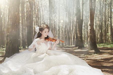woman in white wedding dress playing violin thumbnail
