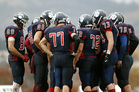 group of football players gathered together thumbnail