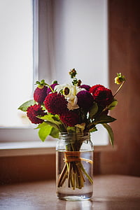 bouquet of red and purple flowers in clear glass mason jar vase thumbnail