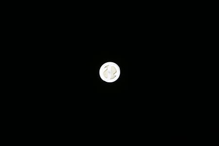 round silver-colored coin against black background thumbnail
