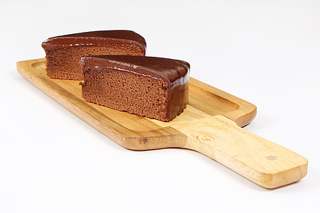two slices of chocolate cake on brown chopping board thumbnail