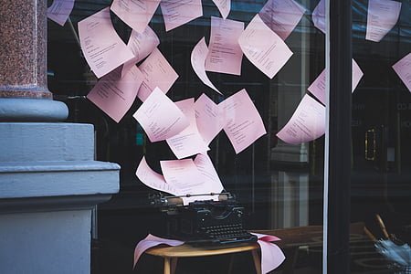 pink notepads flying above black typewriter thumbnail